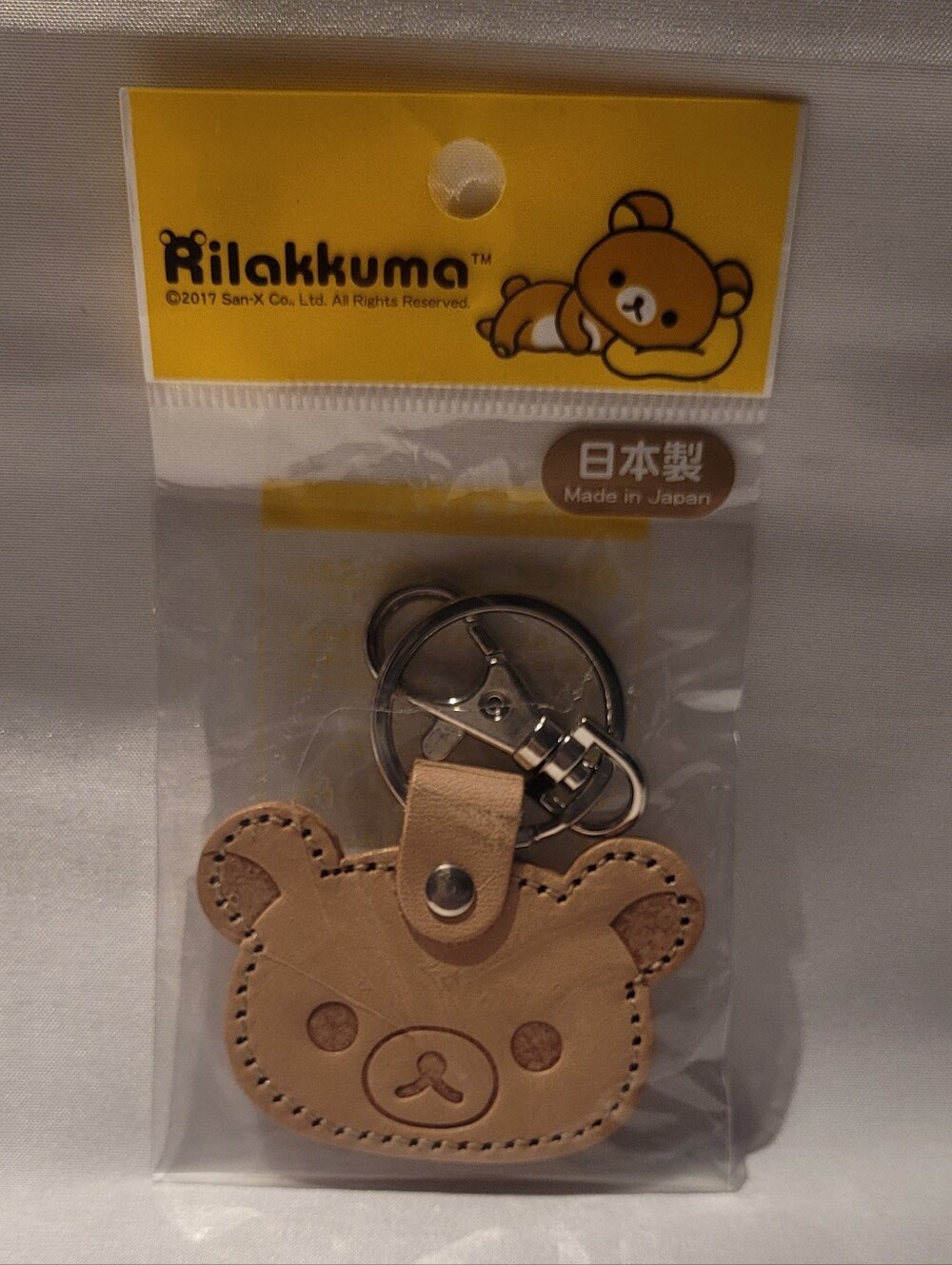 NWT San-X Rilakkuma face-shaped leather keychain crafted in Japan.